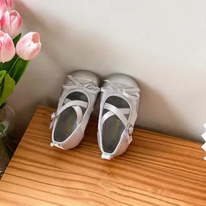 Detailed view of silver baby girl princess shoes with soft soles and bow accents