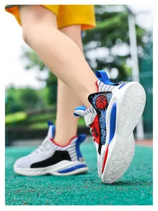 Detail view of boys' breathable mesh basketball shoes on a green outdoor court