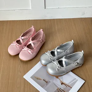 Macro detail view of elegant pink and silver toddler princess shoes with bow accents.