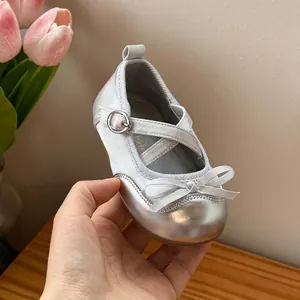 Detail view of silver baby princess shoes with soft soles and bow decoration