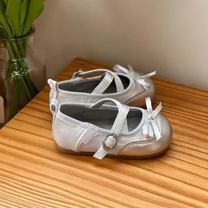 Elegant silver baby girl princess shoes with soft soles and a decorative bow ornament