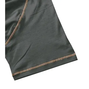 Detailed close-up of contrast stitching on a grey men's short sleeve cotton Henley T-shirt