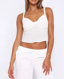 Detailed view of white twisted front crop camisole tank top on model for summer fashion