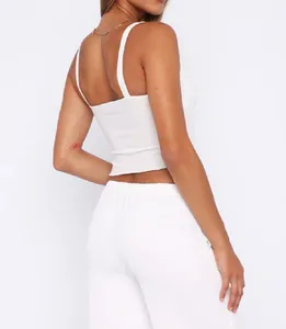 Back view detail of a minimalist white cropped camisole with thin spaghetti straps