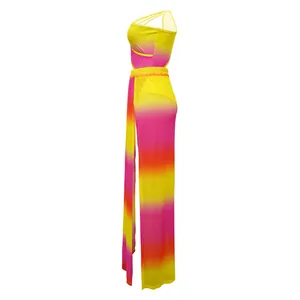 Side view of vibrant gradient print bodysuit and high-slit maxi skirt set