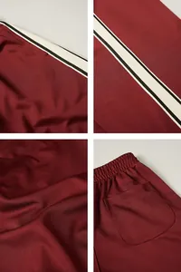 Close-up detail of burgundy men's sports pants with side stripes and back pocket