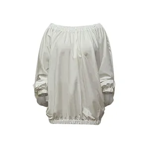 Close-up of white loose batwing sleeve blouse with elasticated hem and cuffs
