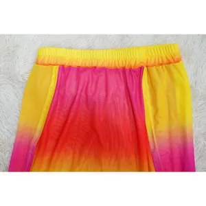 Detailed close-up showing the yellow to pink gradient mesh fabric and elastic waistband