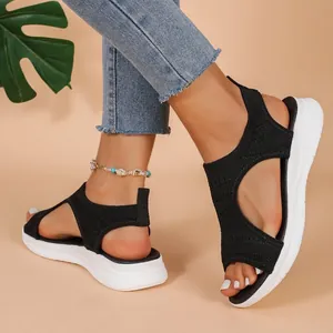 Close-up of black breathable knit platform sandals with white sport wedge sole