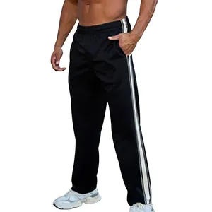 Close-up of men's loose straight-leg sports pants with classic side stripe design
