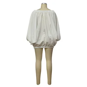 Back view of white batwing sleeve dress showing the puffy balloon hem design