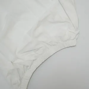 Detailed close-up view of the elasticated waistband on this white batwing sleeve summer dress