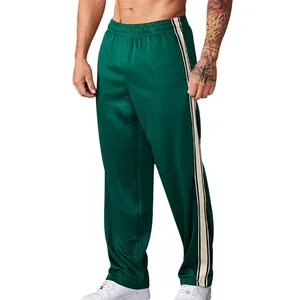 Focus on the side stripe detail and loose straight fit of these green sports pants
