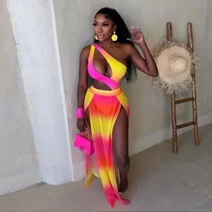 Two-piece pink and yellow ombre resort set with cutout bodysuit and high slit skirt
