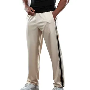 Detailed view of men's cream-colored casual pants featuring black side stripes and loose fit.