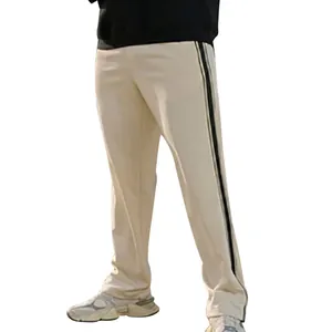 Detail view of men's cream straight-leg casual pants with black side stripes.