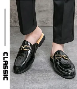Men's black patent leather mules with crocodile texture and gold metal buckle detail.