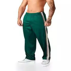 Men's loose wide-leg track pants with athletic side stripes in deep green