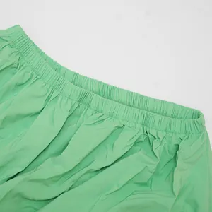 Close-up detail of the comfortable elastic gathered waistband on a mint green summer dress.