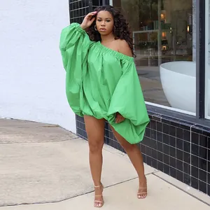 Stylish green off-shoulder plus size mini dress featuring dramatic oversized lantern sleeves