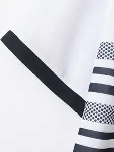 Detailed macro view of white sporty shirt sleeve with black ribbed cuff and striped dot pattern