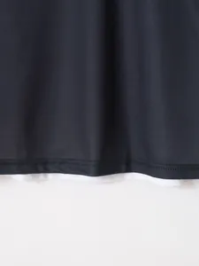 Close-up view of the breathable mesh fabric and double-stitched hem on a men's sports polo