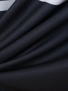 Macro view of breathable sportswear mesh fabric texture with a classic white stripe detail