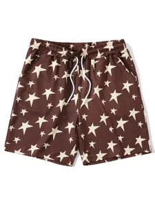 Detailed view of brown men's casual beach shorts featuring all-over cream star patterns
