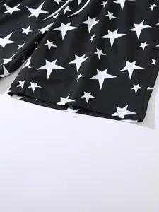 Macro view of the white star pattern and fabric texture on black men's beach shorts