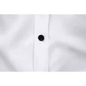 Close-up view showing the high-quality fabric and black button of a white men's dress shirt
