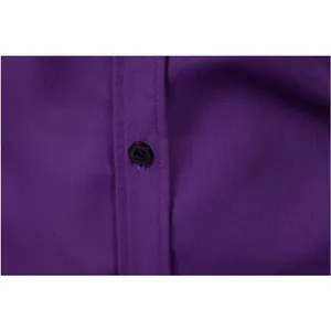 Macro detail of high-quality purple men's formal shirt showing black button and fabric