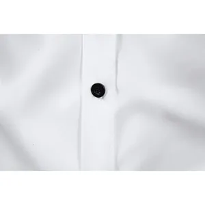 Close-up detail of a single black button on a premium white business dress shirt fabric