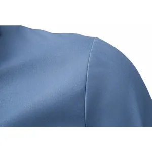 Macro view showing the high-quality shoulder seam detail of a blue business shirt