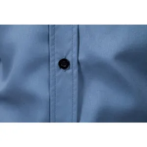 Close-up detail showing the high-quality blue fabric texture and neat stitching on a shirt