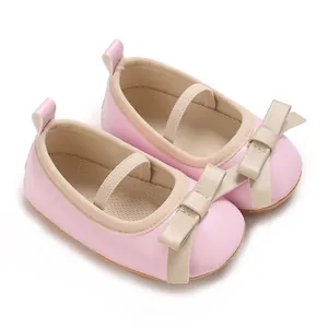 Detail shot of pink baby princess flats with beige bow and breathable mesh lining.