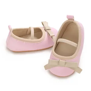 Close-up view of elegant pink baby princess shoes featuring a beige bow decoration