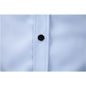 Macro detail showing a black resin button and precision stitching on light blue fabric.