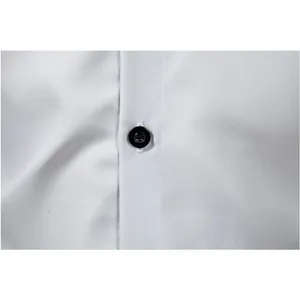 Close-up detail of a classic men's dress shirt featuring a black button and smooth fabric