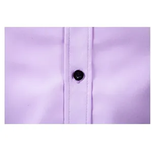 Close-up macro view of a black button on lavender long-sleeved business dress shirt