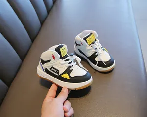 Close-up detail of kids' high-top sneakers featuring a color-blocked design and soft rubber sole