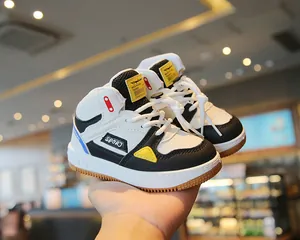 Detailed close-up of color-blocked children's high-top sneakers featuring soft soles