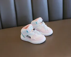 Close-up of pink and white children's high-top sneakers with a soft comfortable sole