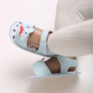 Detail view of light blue baby shark sandals with soft soles and velcro straps.