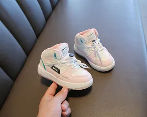 Detailed macro view showing soft sole and pink color block design on kids high-top sneakers.