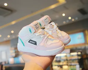 Close-up of pink and white color block high-top sneakers with soft sole for kids.