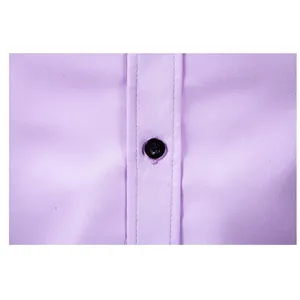 Close-up detail of a black button on a lavender long-sleeved formal dress shirt for men