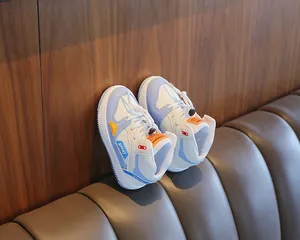 Close-up detail of children's blue and white high-top sneakers with patchwork design