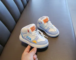 Detail view of blue and white kids high-top sneakers with soft non-slip sole and sport logo.