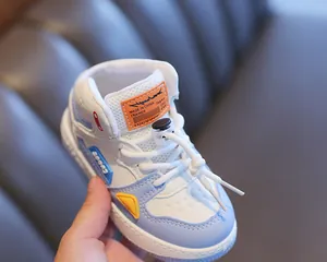 Close-up of children's high-top color-block sneaker featuring breathable mesh and drawstring.