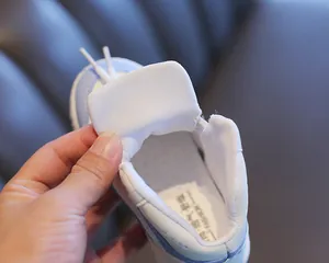 Detailed macro view of breathable lining and cushioned insole of kids' high-top sneakers